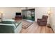Cozy living room with neutral walls, wood flooring, and sliding glass doors to the lanai at 169 Fallwood St, Fern Park, FL 32730