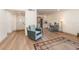 Inviting living area with wood floors flowing into an open floor plan with dining and kitchen at 169 Fallwood St, Fern Park, FL 32730