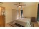 Comfortable bedroom with natural light and wood floors and black out drapes at 169 Fallwood St, Fern Park, FL 32730