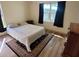 Comfortable bedroom with natural light and wood floors and black out drapes at 169 Fallwood St, Fern Park, FL 32730