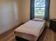 Simple bedroom with comfortable bed, wood floors, and natural lighting from a large window at 169 Fallwood St, Fern Park, FL 32730