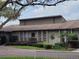 Exterior of a community clubhouse with a well-manicured lawn and tropical landscaping at 169 Fallwood St, Fern Park, FL 32730
