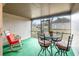 A screened porch featuring an outdoor seating area and a comfortable rocking chair at 169 Fallwood St, Fern Park, FL 32730