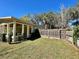View of backyard featuring privacy fence, green grass, and porch with seating at 171 Church St, Geneva, FL 32732