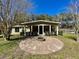 Backyard with a fire pit and covered patio at 171 Church St, Geneva, FL 32732