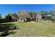 Large backyard with green grass, covered patio, and privacy fence at 171 Church St, Geneva, FL 32732