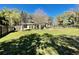 Large backyard with green grass, covered patio, and privacy fence at 171 Church St, Geneva, FL 32732