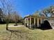 Backyard featuring a cozy, covered porch and brick fire pit perfect for entertaining at 171 Church St, Geneva, FL 32732