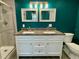 Bathroom features a double vanity with granite countertop, tile floors, and modern lighting fixtures at 171 Church St, Geneva, FL 32732