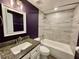 Bathroom featuring a granite countertop, undermount sink, tile floor, and a bathtub with tile surround at 171 Church St, Geneva, FL 32732