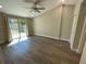Bright bedroom with wood floors, ceiling fan, and sliding glass door to the backyard at 171 Church St, Geneva, FL 32732