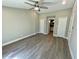 Bedroom boasts sleek wood-look floors, neutral walls, ceiling fan, and easy access to the ensuite bathroom at 171 Church St, Geneva, FL 32732