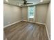 Bedroom with new paint, baseboards, luxury vinyl flooring, and window at 171 Church St, Geneva, FL 32732