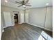 This bedroom offers tile floors, modern paint, ceiling fan, and access to an ensuite bathroom and closets at 171 Church St, Geneva, FL 32732