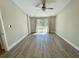 Bright bedroom features wood-look floors, modern paint, recessed lighting, and sliding glass door to the yard at 171 Church St, Geneva, FL 32732