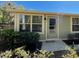 Close-up of the home's entrance, highlighting the front door, landscaping and window features at 171 Church St, Geneva, FL 32732