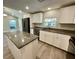 View of updated kitchen with granite countertops, stainless appliances, and eat-in kitchen at 171 Church St, Geneva, FL 32732