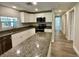 Eat-in kitchen features granite counters, stainless appliances, and white cabinetry at 171 Church St, Geneva, FL 32732
