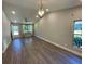 Bright living room with wood-look floors and natural light streaming through the windows at 171 Church St, Geneva, FL 32732