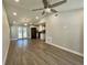 Spacious living room featuring vaulted ceilings, modern ceiling fan, and connection to the kitchen at 171 Church St, Geneva, FL 32732