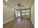 Bright living room with wood-look floors and natural light streaming through the windows at 171 Church St, Geneva, FL 32732