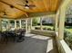 Covered patio with wood ceiling, ceiling fans, and outdoor dining set at 171 Church St, Geneva, FL 32732