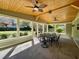 Covered patio with wood ceiling, ceiling fans, and outdoor dining set at 171 Church St, Geneva, FL 32732