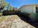Side yard featuring a partial privacy fence and green and sandy grass at 171 Church St, Geneva, FL 32732