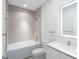 Clean and modern bathroom with a shower-tub combo and vanity at 17442 Hidden Forest Dr, Clermont, FL 34714