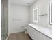 Contemporary bathroom with dual sinks, wood-style floor, and glass shower at 17442 Hidden Forest Dr, Clermont, FL 34714