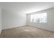Light-filled bedroom with carpeting and window at 17442 Hidden Forest Dr, Clermont, FL 34714