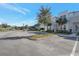 Modern townhome with a well-maintained parking lot, landscaping, and a clear blue sky at 17442 Hidden Forest Dr, Clermont, FL 34714
