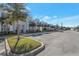 New townhomes with modern architecture, palm trees, and a parking area, showcasing community living at 17442 Hidden Forest Dr, Clermont, FL 34714