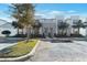 Exterior shot of modern townhomes with palm trees, landscaping, and visible parking spaces at 17442 Hidden Forest Dr, Clermont, FL 34714