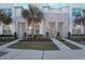 Contemporary townhome with stacked stone accents, manicured landscaping, and bright, modern facade at 17442 Hidden Forest Dr, Clermont, FL 34714