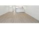 Open-concept living area with wood floors leading to a modern kitchen at 17442 Hidden Forest Dr, Clermont, FL 34714