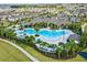 Aerial view showcasing the resort-style pool with palm trees and the surrounding community at 18046 Cider Mill Ln, Winter Garden, FL 34787