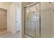 Bathroom featuring a tile shower with glass doors, next to the walk-in closet at 18046 Cider Mill Ln, Winter Garden, FL 34787