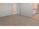 Spacious carpeted bedroom with a view of the ensuite bathroom and walk-in closet at 18046 Cider Mill Ln, Winter Garden, FL 34787