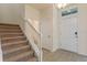 Bright entryway with stairway, white trim, tile floor and direct access to half bathroom at 18046 Cider Mill Ln, Winter Garden, FL 34787