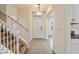 Inviting entryway with stairway, tile flooring, direct bathroom access and kitchen view at 18046 Cider Mill Ln, Winter Garden, FL 34787