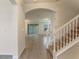Inviting entryway with tile flooring, stairway and arched doorway leading to the living area at 18046 Cider Mill Ln, Winter Garden, FL 34787