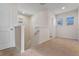 Upstairs hallway with neutral carpet and natural light at 18046 Cider Mill Ln, Winter Garden, FL 34787