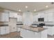 Modern kitchen featuring white cabinets, granite countertops and a spacious island with sink at 18046 Cider Mill Ln, Winter Garden, FL 34787