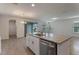 Open kitchen features granite counters, stainless steel appliances, and an island with a sink at 18046 Cider Mill Ln, Winter Garden, FL 34787