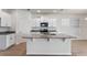 Modern kitchen with white cabinets, stainless steel appliances, granite countertops, and a spacious island at 18046 Cider Mill Ln, Winter Garden, FL 34787