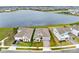 Aerial view of a suburban neighborhood with a tranquil lake in the background at 18405 Mowry Ct, Orlando, FL 32827