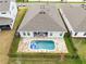 Aerial view of a home showcasing the fenced backyard with a beautiful in-ground pool at 18405 Mowry Ct, Orlando, FL 32827