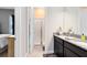 Modern bathroom with double sinks, granite countertops, and a glass-enclosed shower at 18405 Mowry Ct, Orlando, FL 32827