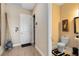 This half bathroom has wood-look tile flooring, a sleek toilet, and minimalist decor, with a view to the entryway at 18405 Mowry Ct, Orlando, FL 32827